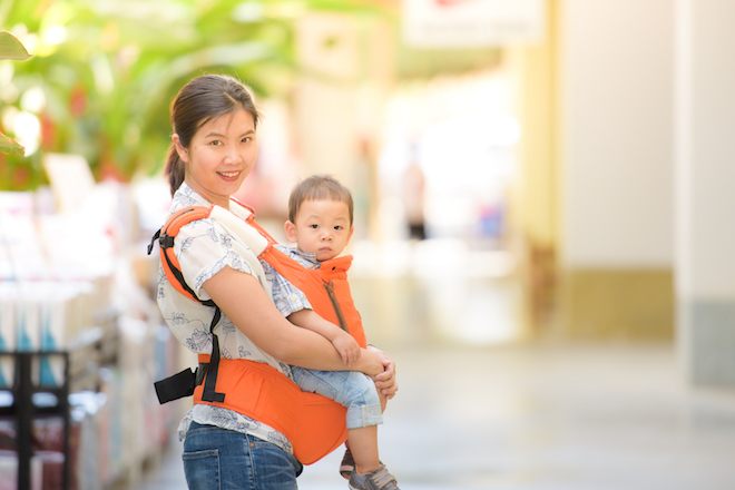 domestic helper in Hong Kong holding a baby